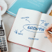 A founder mapping growth hacking experiments and scalable growth systems in a notebook, showing how structured testing turns ideas into repeatable business growth.